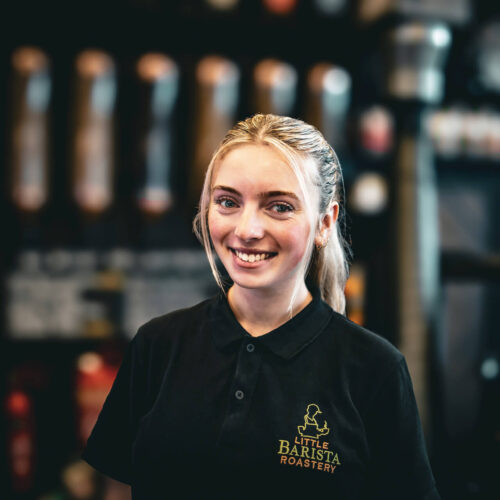 Francesca the barista at Little Barista – preparing coffee behind the counter in a specialty café