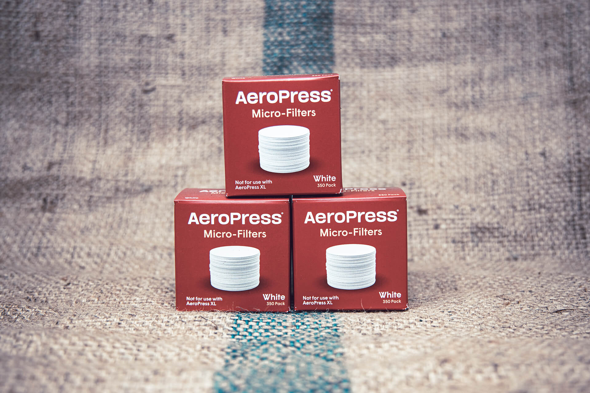 Three boxes of AeroPress micro filters stacked together for multiple months of clean brewing