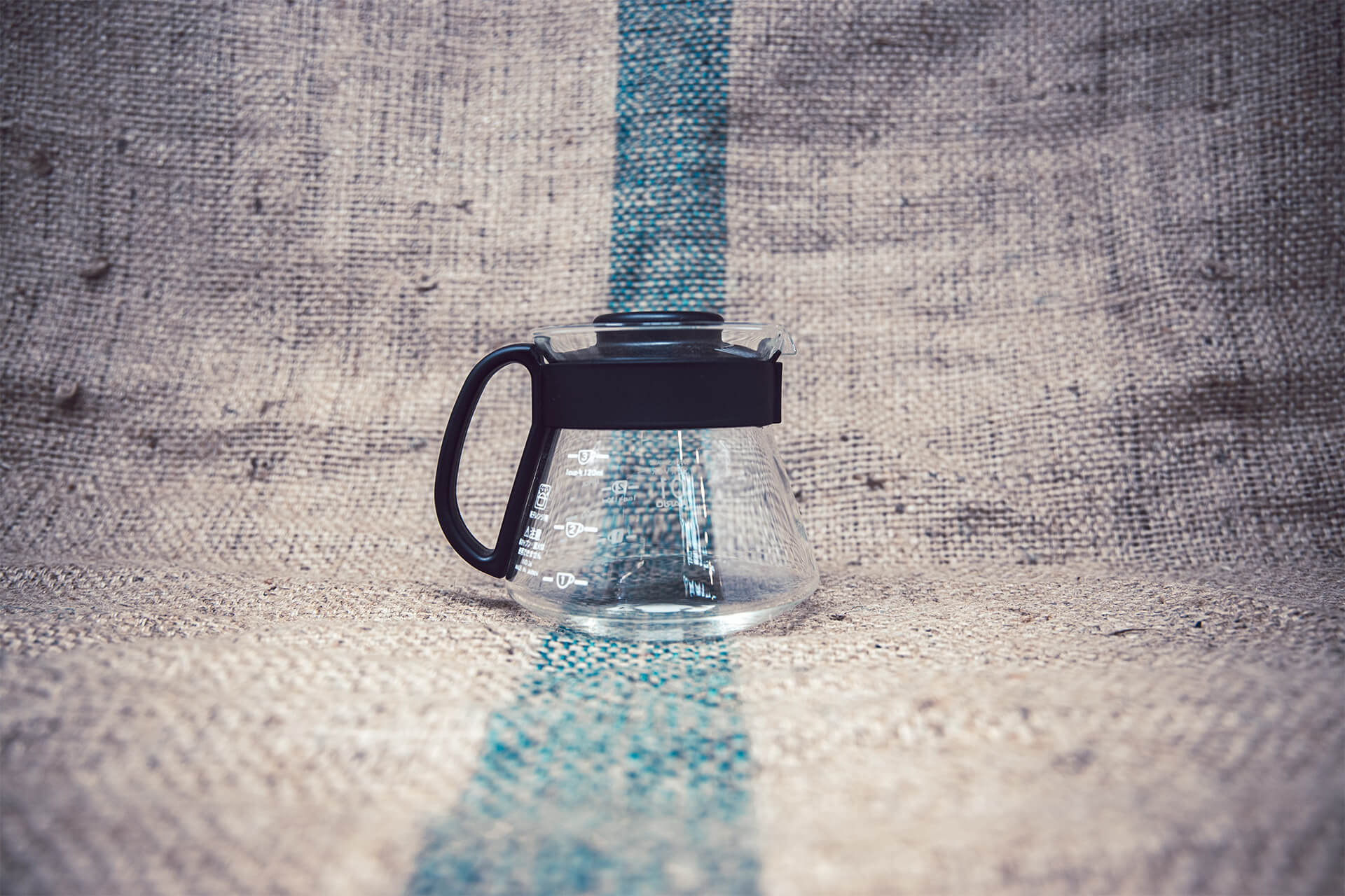 Glass Hario V60 coffee server with ergonomic handle and measurement markings for manual brewing